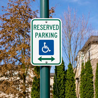 White 12"x18" reserved handicap parking sign with green border, blue symbol, and double arrows on a pole.