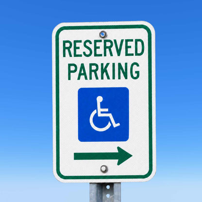 White 12x18 MUTCD reserved handicap parking sign with blue symbol, green text, and right arrow.