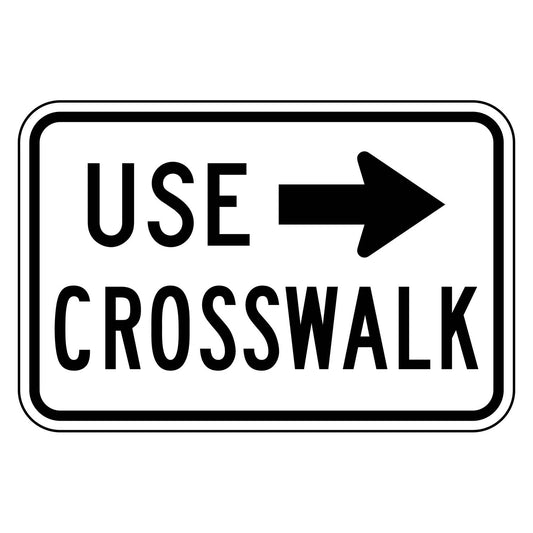 White 18x12 retroreflective sign with black "USE CROSSWALK" text and a right-pointing arrow.