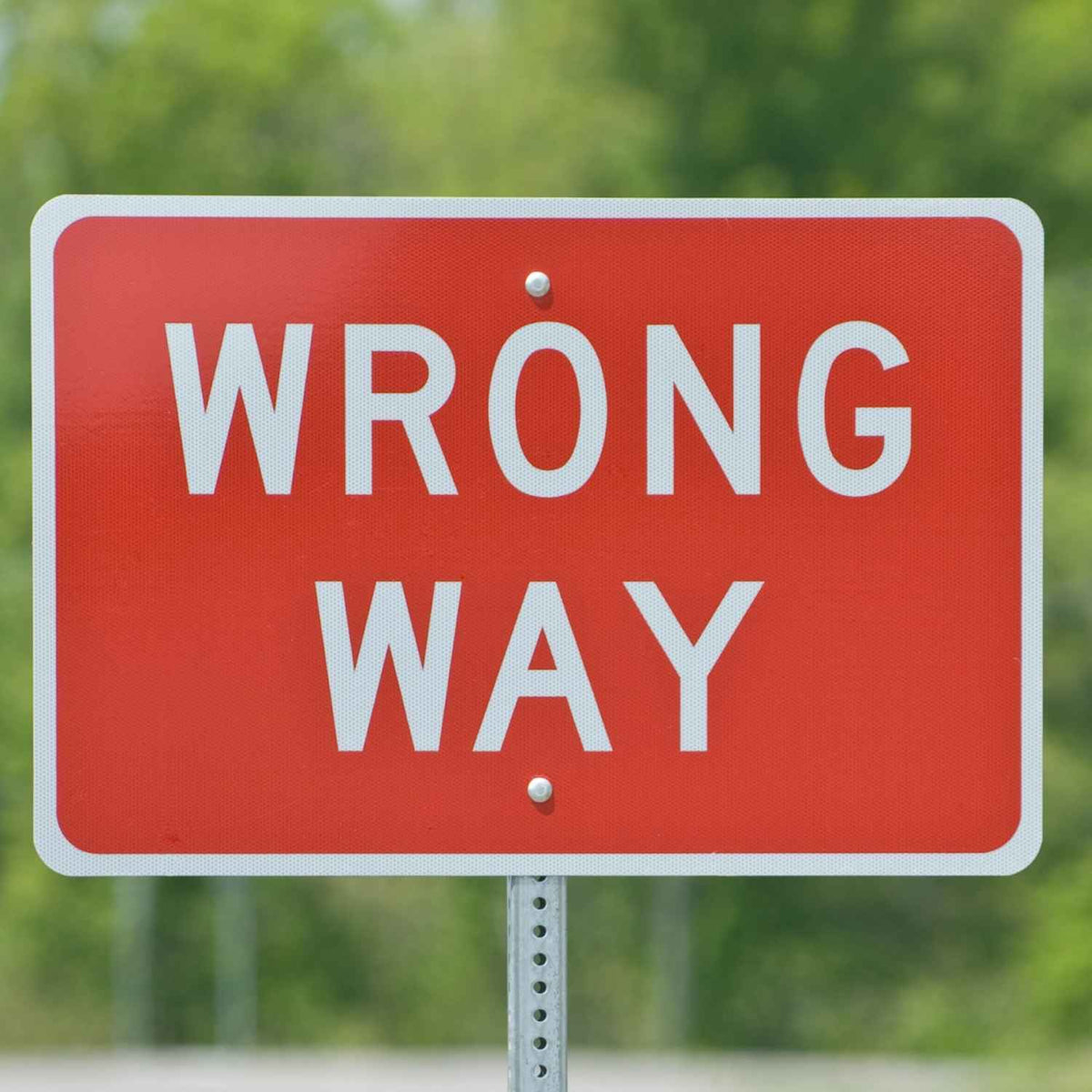 Wrong Way Sign R5-1A - red sign reading WRONG WAY in white, mounted on a U-channel post outdoors