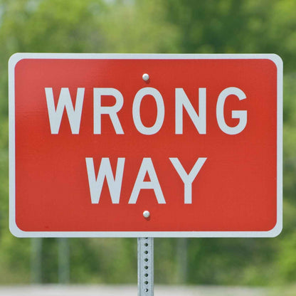 Wrong Way Sign R5-1A - red sign reading WRONG WAY in white, mounted on a U-channel post outdoors