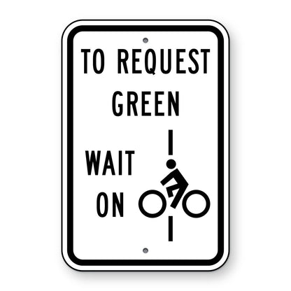 Bicycle Detector Sign R10-22 - white vertical rectangle sign reading TO REQUEST GREEN WAIT ON with a black bicyclist symbol on a vertical line
