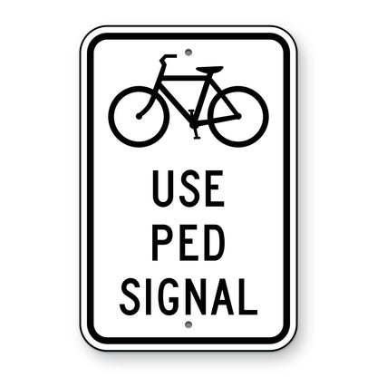 Bicycles Use Pedestrian Signal Sign R9-5 - white vertical rectangle sign with a black bicycle symbol above the words USE PED SIGNAL