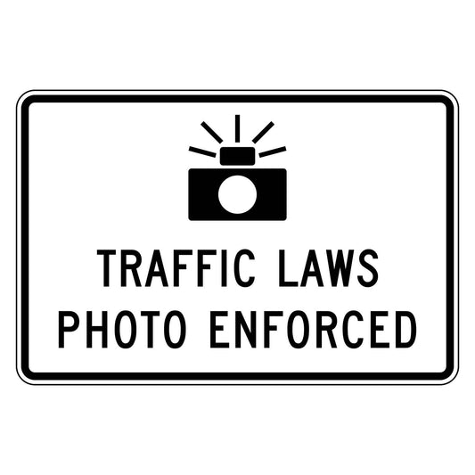 White R10-18 sign with black camera symbol and "TRAFFIC LAWS PHOTO ENFORCED" text.