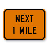 Construction Next 1 Mile Plaque W7-3aP - orange rectangular plaque reading NEXT 1 MILE in black