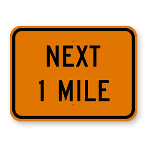 Construction Next 1 Mile Plaque W7-3aP - orange rectangular plaque reading NEXT 1 MILE in black