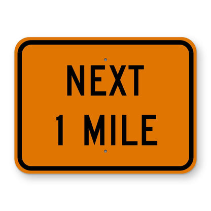 Construction Next 1 Mile Plaque W7-3aP - orange rectangular plaque reading NEXT 1 MILE in black