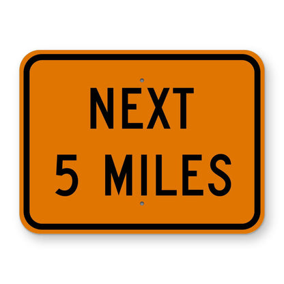 Construction Next 5 Miles Plaque W7-3aP - orange rectangular plaque reading NEXT 5 MILES in black