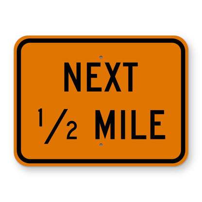 Construction Next 1/2 Mile Plaque W7-3aP - orange rectangular plaque reading NEXT 1/2 MILE in black