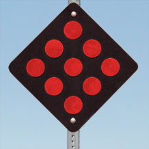 End of Road Marker OM4-2 - black diamond marker with nine red reflective dots, mounted on a post