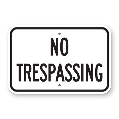 No Trespassing Sign - white horizontal rectangle sign reading NO TRESPASSING in black