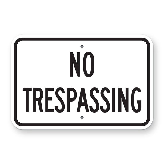 No Trespassing Sign - white horizontal rectangle sign reading NO TRESPASSING in black
