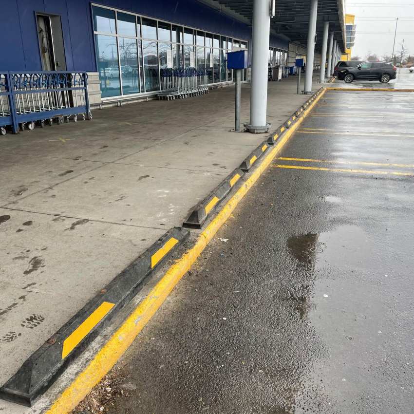 Row of rubber parking blocks along a store sidewalk