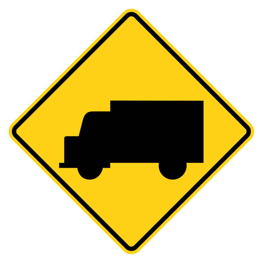 Yellow diamond-shaped W11-10 truck crossing warning sign with black truck symbol.