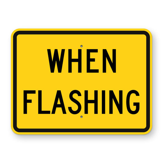 When Flashing Plaque W16-13P - yellow horizontal rectangle plaque reading WHEN FLASHING